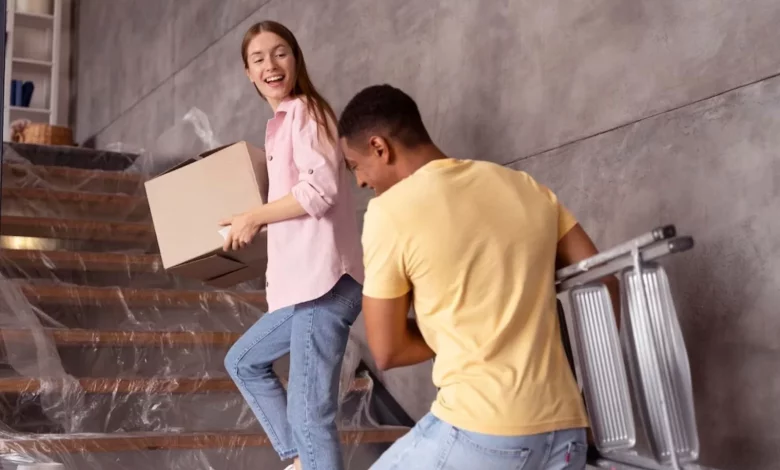 a girl and boy carrying boxes